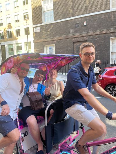 students performing playful photo prompt in a bar