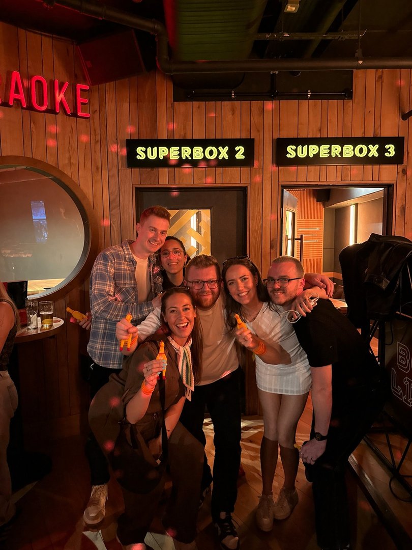 Winning team celebrating at the end of a Chicken Rush hunt, holding rubber chickens