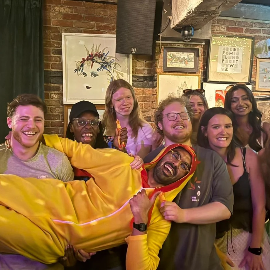 A winning team carrying the captured Chicken through a pub