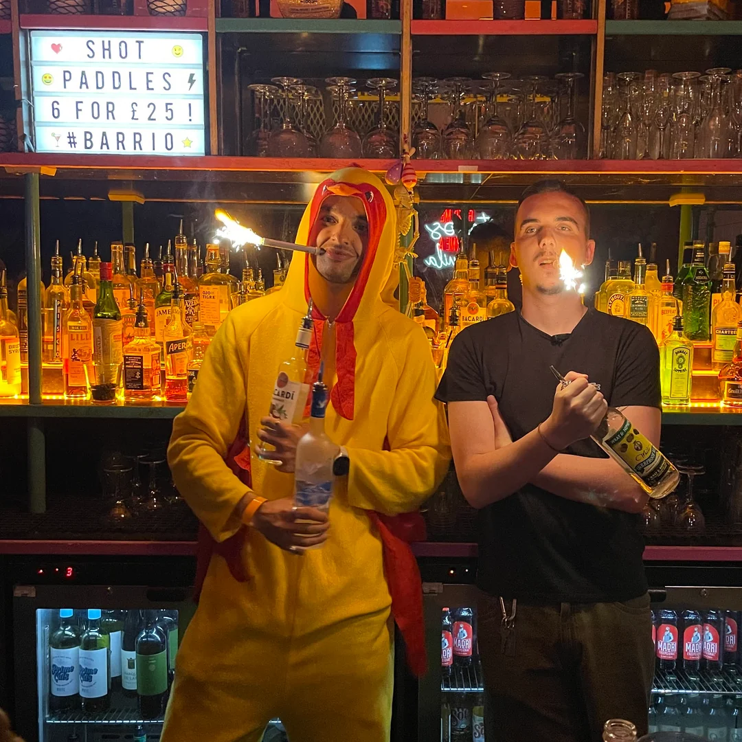 The Chicken celebrating at the bar with sparkler shots