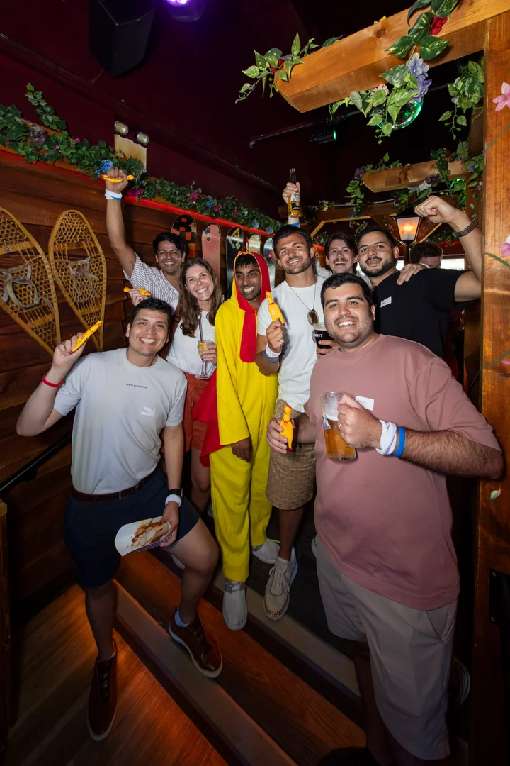 A team celebrating in a pub after the hunt, one of them still in the chicken costume